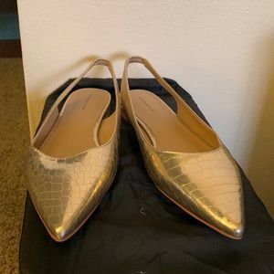 Gold pointed sling back flats.